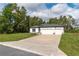 A modern single-story home with a three-car garage and freshly cut lawn in a sunny setting at 13068 Sw 36Th Ct, Ocala, FL 34473