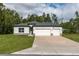 Charming single-story home featuring a spacious three-car garage and a well-manicured lawn at 13068 Sw 36Th Ct, Ocala, FL 34473