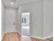 Bright foyer with wood flooring, white trim, and an open doorway leading to another room at 13068 Sw 36Th Ct, Ocala, FL 34473