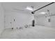 Spacious garage with a water heater, utility door, and overhead lighting at 13068 Sw 36Th Ct, Ocala, FL 34473