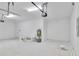 Clean and well-lit garage with a water heater, ample storage space, and room for multiple vehicles at 13068 Sw 36Th Ct, Ocala, FL 34473