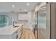 Bright kitchen boasts white cabinets, stainless appliances, a large island with sink and quartz countertops at 13068 Sw 36Th Ct, Ocala, FL 34473