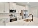 A beautifully designed kitchen with quartz counters, stainless steel appliances, and modern fixtures at 13068 Sw 36Th Ct, Ocala, FL 34473