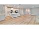 Modern, open-concept kitchen with sleek island, laminate floors and state-of-the-art stainless steel appliances at 13068 Sw 36Th Ct, Ocala, FL 34473
