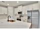 Modern kitchen featuring white cabinetry, stainless steel appliances, and a large center island with quartz countertops at 13068 Sw 36Th Ct, Ocala, FL 34473
