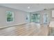 Bright living space showcasing laminate flooring, natural light, and seamless flow to the outdoors and kitchen at 13068 Sw 36Th Ct, Ocala, FL 34473