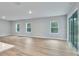 Open-concept living area featuring wood floors, natural light, and seamless access to the outdoors at 13068 Sw 36Th Ct, Ocala, FL 34473