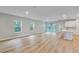 Expansive living room features an open concept, durable laminate floors and slider doors to the patio at 13068 Sw 36Th Ct, Ocala, FL 34473