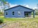 The backyard features a large, covered patio and ample space for outdoor activities with mature tree coverage at 13297 Sw 69Th Pl, Ocala, FL 34481