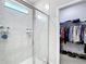 Bathroom featuring a glass enclosed shower, and walk-in closet space at 13297 Sw 69Th Pl, Ocala, FL 34481