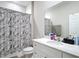Bathroom featuring a vanity with a white countertop and a shower with gray patterned curtain at 13297 Sw 69Th Pl, Ocala, FL 34481