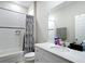 Bathroom featuring a bathtub and shower with a gray patterned curtain and a white countertop at 13297 Sw 69Th Pl, Ocala, FL 34481
