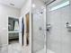 Bright bathroom featuring walk-in shower with glass doors, and access to the toilet and bedroom at 13297 Sw 69Th Pl, Ocala, FL 34481