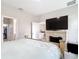 Comfortable bedroom featuring neutral walls, an electric fireplace, and a television at 13297 Sw 69Th Pl, Ocala, FL 34481