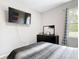 Cozy bedroom with a window and a mounted TV at 13297 Sw 69Th Pl, Ocala, FL 34481
