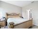 A spacious bedroom featuring an ornate bed frame and ensuite bath entrance at 13297 Sw 69Th Pl, Ocala, FL 34481