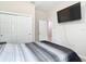 Bedroom featuring a double closet, TV, and access to a bathroom at 13297 Sw 69Th Pl, Ocala, FL 34481
