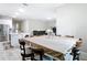 Open-concept dining room with large table, adjacent to white kitchen with stainless steel appliances at 13297 Sw 69Th Pl, Ocala, FL 34481