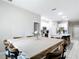 Large dining room featuring seating for eight, open to the kitchen and additional rooms at 13297 Sw 69Th Pl, Ocala, FL 34481