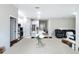 View of open concept floor plan into dining room, kitchen and living space with white cabinets and gray flooring at 13297 Sw 69Th Pl, Ocala, FL 34481