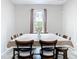 Well-lit dining room featuring a large table with seating for eight and simple decor at 13297 Sw 69Th Pl, Ocala, FL 34481