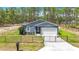 Beautifully maintained home with a two-car garage and gated fence, surrounded by lush grass at 13297 Sw 69Th Pl, Ocala, FL 34481