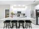 Beautiful kitchen island with pendant lights, white cabinets and stainless appliances at 13297 Sw 69Th Pl, Ocala, FL 34481