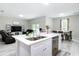 Modern kitchen with white countertops, stainless steel appliances, island, and open concept design at 13297 Sw 69Th Pl, Ocala, FL 34481
