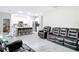 Open concept living room, with tile flooring, leather furniture, and a view of the kitchen area at 13297 Sw 69Th Pl, Ocala, FL 34481