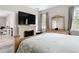 Main bedroom features fireplace, ensuite, and walk-in closet with a large bed at 13297 Sw 69Th Pl, Ocala, FL 34481