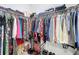 Spacious walk-in closet well-stocked with clothes, shoes, and bags at 13297 Sw 69Th Pl, Ocala, FL 34481