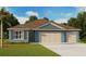 Charming single-Gathering home showcasing a large front-facing two car garage and inviting front yard at 1375 Scarlett Sage Ln, Sanford, FL 32773