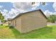 Exterior backyard view showcasing the beige siding, and architectural design of this single Gathering home at 1390 E Wabash St, Bartow, FL 33830