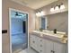 Bathroom with double sink vanity, framed mirror, and modern lighting, providing a functional space at 1390 E Wabash St, Bartow, FL 33830
