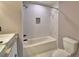Bright bathroom showcasing a tub with tiled walls and sleek fixtures, accompanied by a modern toilet at 1390 E Wabash St, Bartow, FL 33830
