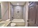 Bright bathroom features a shower with gray tile and a decorative mosaic tile accent at 1390 E Wabash St, Bartow, FL 33830