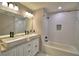 Stylish bathroom featuring double sinks, modern fixtures, and a tub with decorative tile surround at 1390 E Wabash St, Bartow, FL 33830