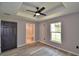 Bedroom with wood floors, bathroom access, and ceiling fan at 1390 E Wabash St, Bartow, FL 33830