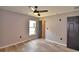 Cozy bedroom with wood-look floors, ceiling fan, and view of closet, offering ample space at 1390 E Wabash St, Bartow, FL 33830