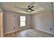 Bedroom with wood floors, ceiling fan, and recessed ceiling at 1390 E Wabash St, Bartow, FL 33830