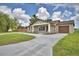 Charming single-story home featuring a decorative gable, covered front porch, and a long driveway at 1390 E Wabash St, Bartow, FL 33830