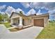 Charming single-story home featuring a decorative gable, covered front porch, and attached garage at 1390 E Wabash St, Bartow, FL 33830