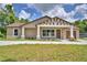 Charming single-story home featuring a decorative gable, covered front porch, and a well-manicured lawn at 1390 E Wabash St, Bartow, FL 33830
