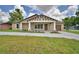 Charming single Gathering home with beautiful front porch, fresh landscaping, driveway, and attached garage at 1390 E Wabash St, Bartow, FL 33830