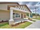 Charming single-story home featuring a decorative gable, covered front porch, and professionally landscaped yard at 1390 E Wabash St, Bartow, FL 33830
