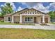 Charming single-story home featuring a decorative gable, covered front porch, and a well-manicured lawn at 1390 E Wabash St, Bartow, FL 33830