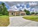 Charming single-story home featuring a decorative gable, covered front porch, and a long driveway at 1390 E Wabash St, Bartow, FL 33830