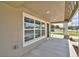 Covered front porch with large picture window and craftsman style trim at 1390 E Wabash St, Bartow, FL 33830