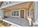 Covered front porch with craftsman style trim, large picture window, and new landscaping at 1390 E Wabash St, Bartow, FL 33830