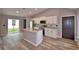 Kitchen with white cabinets, stainless steel appliances, and an island with a sink at 1390 E Wabash St, Bartow, FL 33830
